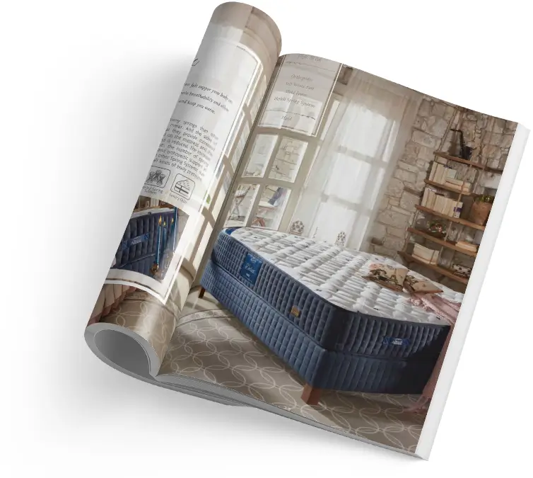 Na obrázku je otevřený časopis s reklamní stránkou, na níž je prezentována stylová ložnice s jednolůžkovou postelí vybavenou modrou matrací. Matrace, vyvedená v jemných odstínech modré a bílé, vypadá mohutně a pohodlně, zdůrazňující koncept kvalitní matrace pro zdravý spánek. Prostor je osvětlen přirozeným světlem, které prochází skrze velká okna, a dodává místnosti pocit tepla a klidu. Tato scéna naznačuje, že matrace není jen základním prvkem nábytku, ale klíčovou součástí pro dosažení regeneračního odpočinku a vitality.